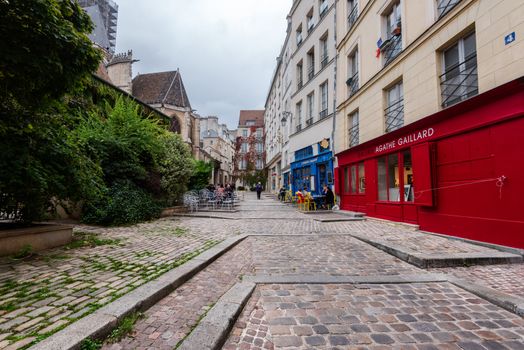 Paris, France -- November 4, 2017 -- A wide  angle photo taken on a side street in Paris with galleries and shops.