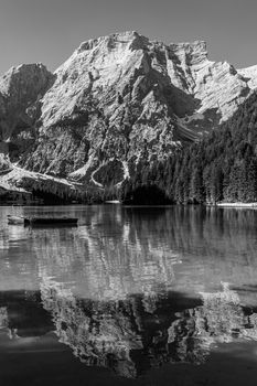 Black and white image of Lake Braies and its reflections, Italian landscape in South Tyrol