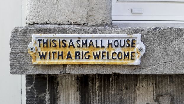 Antwerp, Belgium, July 2020: This is a small house with a big welcome sign on a residential house in the city