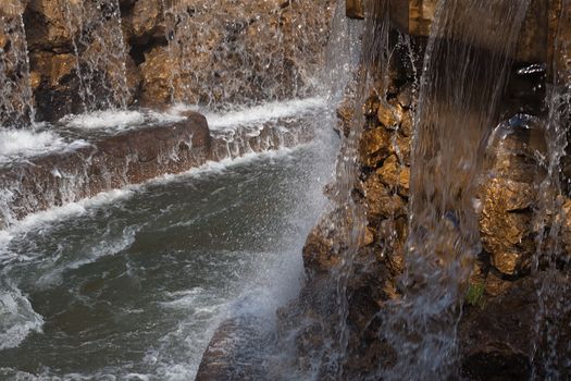 The water falling from above on stones on a decline of day