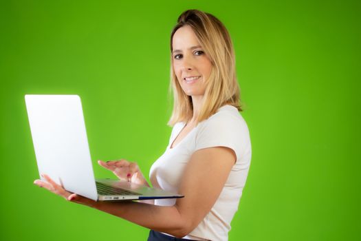 Pretty young woman in white shirt using a computer