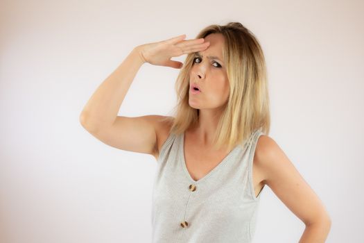 Young woman with short hair wearing a casual dress making the amazed gesture