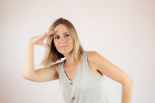 Young woman with short hair wearing a casual dress making a gesture