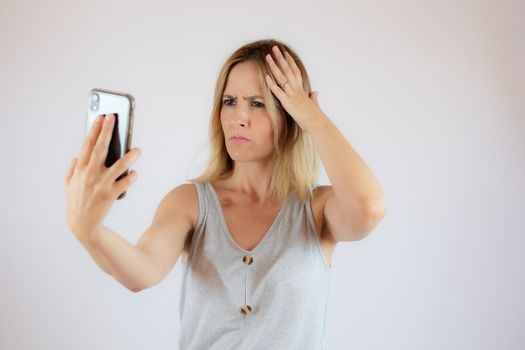 Pretty young woman taking a photo of herself