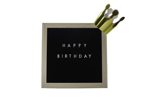 A Sign With a Birch Frame That Says Happy Birthday in White Letters With a Gold Crown on top on a Pure White Background
