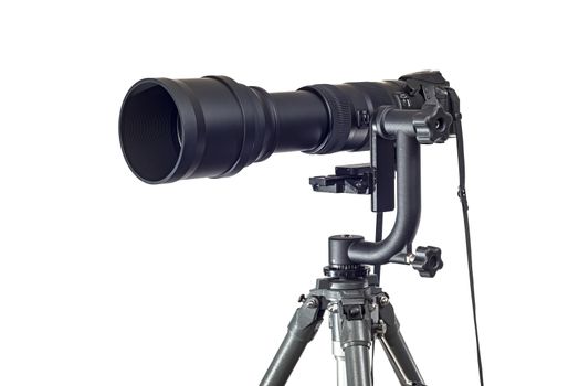 Horizontal shot of a powerful telephoto lens on a digital camera that is mounted to a Gimbal Head on a tripod.