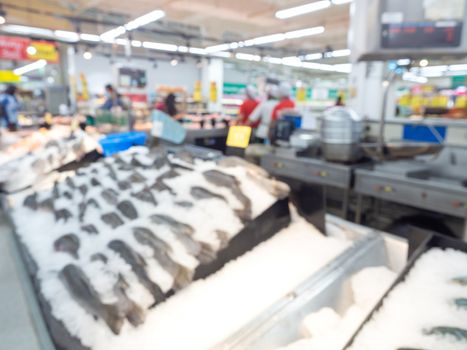 Supermarket blur background. Blurred interior view with fresh fish display in shopping mall.