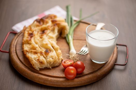 Traditional balkan breakfast - Borek or Burek pie with cheese aranged on wooden table