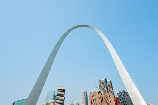 St Louis Gateway Arch with sun on one side as it reaches over downtown city skyline.  Missouri,USA.