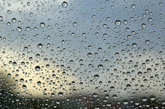 Drops of rain on the window, rainy day. Shallow DOF