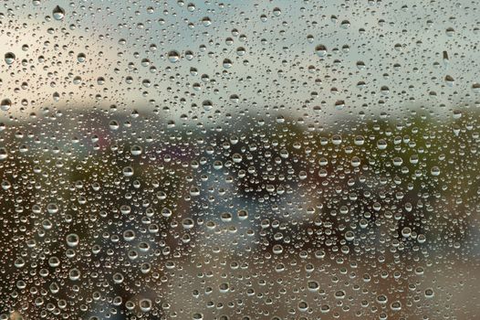 Drops of rain on the window, rainy day. Shallow DOF