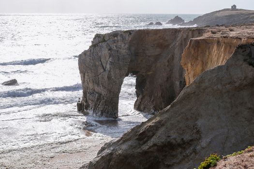 Spectacular cliffs and stone arch Arche de Port Blanc on famous coastline Cote Sauvage, Quiberon, Brittany (Bretagne), France