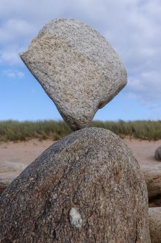 Stone balancing on stone - stone laid on other stone on seacoast