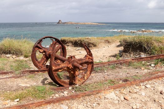 Remains after of granite mining on island Ile Grande in Pleumeur-Bodou in Brittany, France - rails and rusty wheels