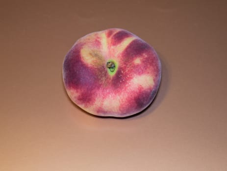 peach nectarine - exotic fruit on a light sunny background, top view