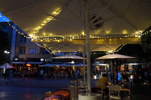 Varna, Bulgaria - July, 13,2020: street cafe on the central street of Varna in the evening.