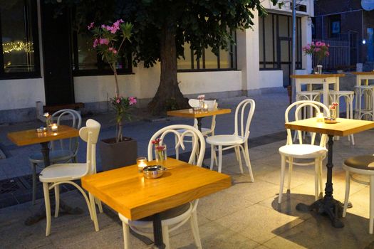 empty tables with candles street cafe on the central street of Varna in the evening.