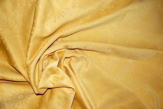 texture of golden textile material in a fold for background close up