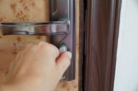 hand closing an interior door close up.