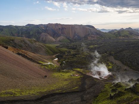Colorful Rhyolit mountain panorma with multicolored volcanos and geothermal fumarole and in Landmannalaugar area of Fjallabak Nature Reserve in Highlands region of Iceland.