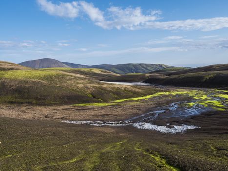 Colorful Rhyolit mountain panorma with snow fiields and multicolored volcanos in Landmannalaugar area of Fjallabak Nature Reserve in Highlands region of Iceland.