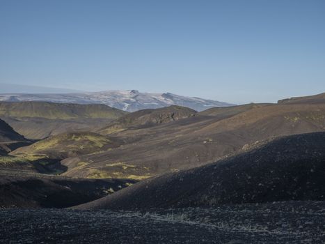 Sunrise view on Myrdalsjokull glacier. from Botnar campsite at Iceland on Laugavegur hiking trail, green valley in volcanic landscape with Early morning pink light.