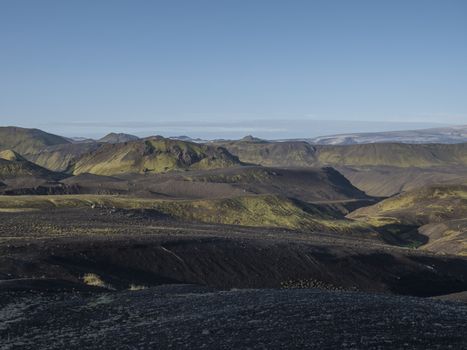 Sunrise view on Myrdalsjokull glacier. from Botnar campsite at Iceland on Laugavegur hiking trail, green valley in volcanic landscape with Early morning pink light.