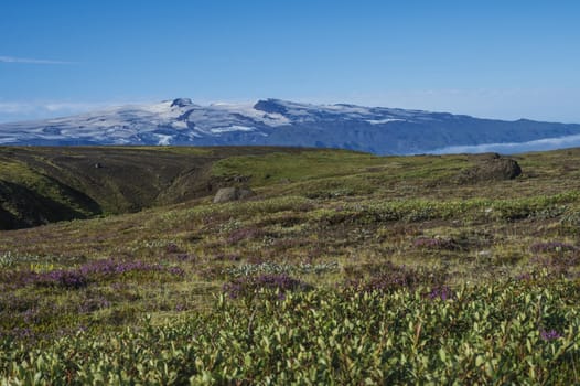 Icelandic landscape with blue Markarfljot river canyon, green hills and eyjafjallajokull volcano glacier. Laugavegur hiking trail. Fjallabak Nature Reserve, Iceland. Summer blue sky.