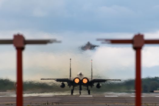 F-15 Eagle aircraft with afterburners departing RAF Lakenheath in England