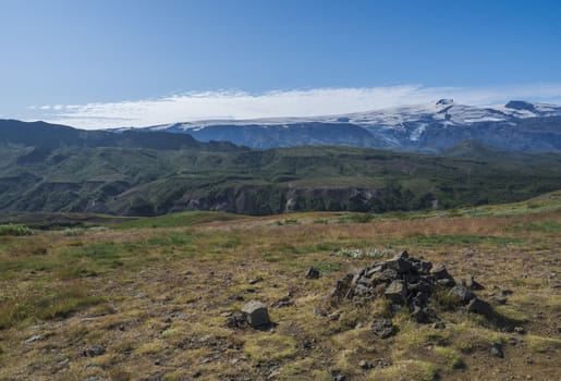 Icelandic landscape with green hills of Thorsmork and eyjafjallajokull volcano glacier. Laugavegur hiking trail. Fjallabak Nature Reserve, Iceland. Summer blue sky.