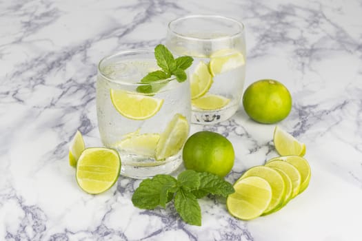 Cold Drink from Lemon cut into pieces in water glass 