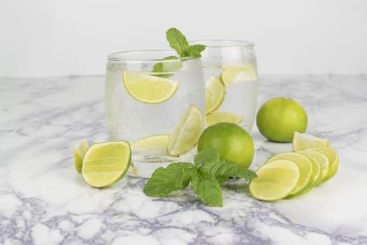 Cold Drink from Lemon cut into pieces in water glass 