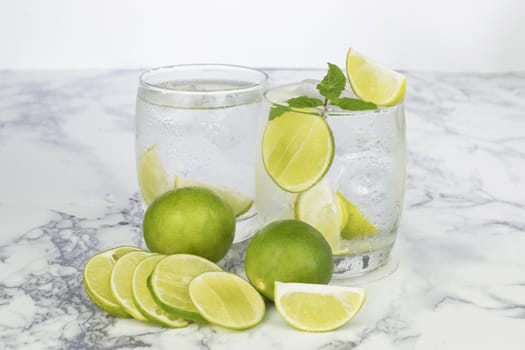Cold Drink from Lemon cut into pieces in water glass 