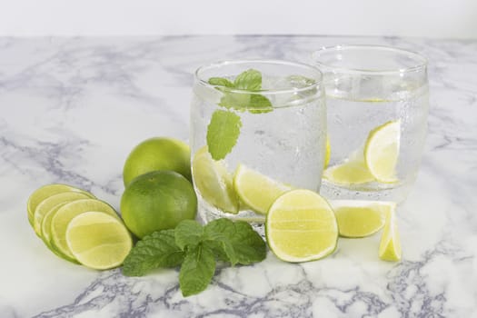 Cold Drink from Lemon cut into pieces in water glass 