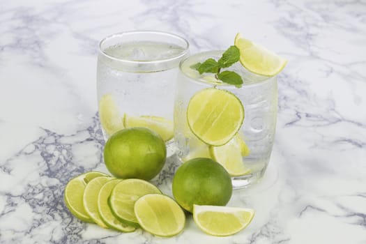 Cold Drink from Lemon cut into pieces in water glass 