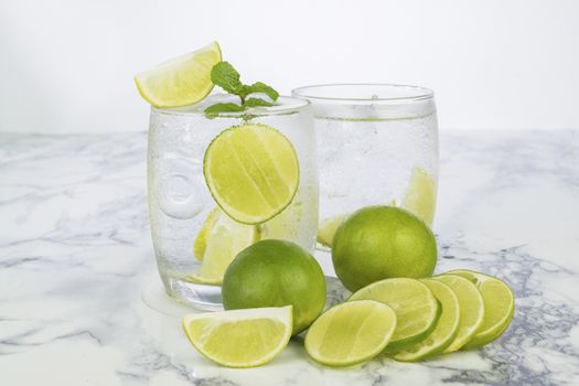 Cold Drink from Lemon cut into pieces in water glass 