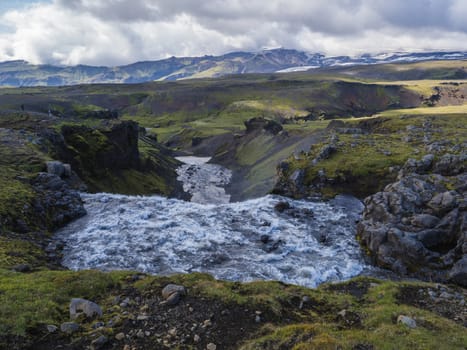 Beautiful lush green Landscape of Skoga river valley cascades near Skogafoss waterfall and Skogar end of Fimmvorduhals hiking trail. South Iceland, Summer blue sky.