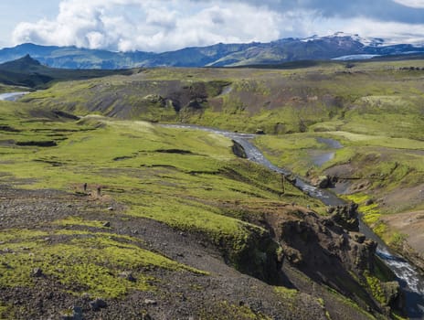 Beautiful lush green Landscape of Skoga river valley cascades near Skogafoss waterfall and Skogar end of Fimmvorduhals hiking trail. South Iceland, Summer blue sky.