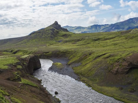 Beautiful lush green Landscape of Skoga river valley cascades near Skogafoss waterfall and Skogar end of Fimmvorduhals hiking trail. South Iceland, Summer blue sky.