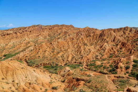 Red sandstone rock formations Seven bulls and Broken heart, Jeti Oguz canyon in Kyrgyzstan, Issyk-Kul region, Central Asia