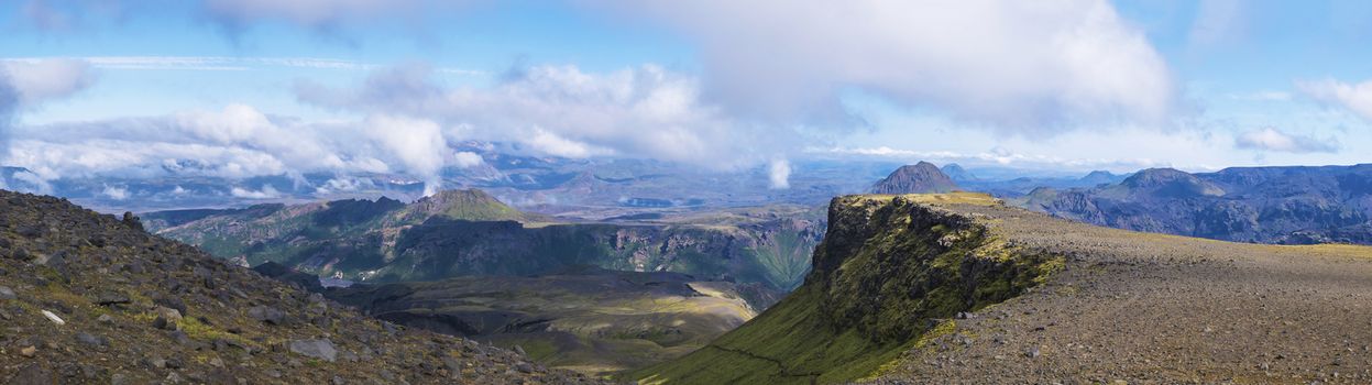 Panoramic breathtaking view on Landscape of Godland and thorsmork with rugged green moss covered rocks and hills, bending river canyon, Iceland, Fimmvorduhals hiking trail. Summer cloudy day