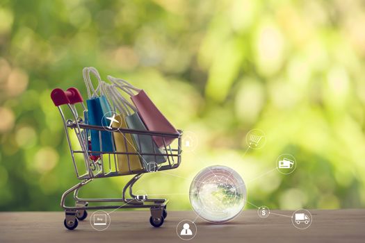 Online shopping, e-commerce concept: Paper shopping bags in a trolley or shopping cart with icon customer network connection. purchase of products on internet can purchase goods from foreign countries