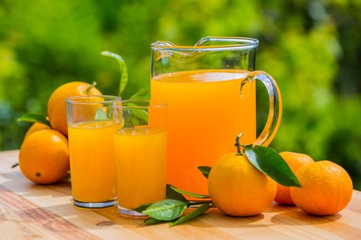 orange juice and oranges on table, outdoor