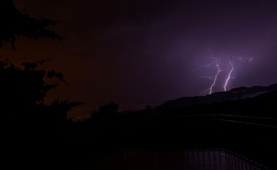 Lightning bolts during an evening thunderstorm over Geres National Park, Amares, Portugal