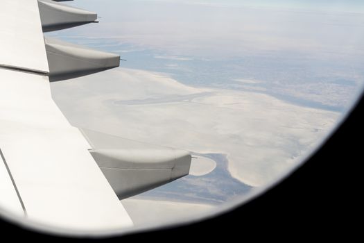 View from an airplane window at high altitude and turbines about Africa.