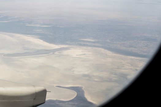 View from an airplane window at high altitude and turbines about Africa.