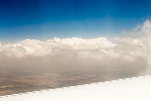 View from an airplane window at high altitude and turbines about Africa.