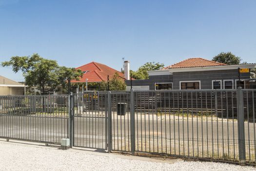 Behind bars in Cape Town, South Africa. Electric fences in residential areas.