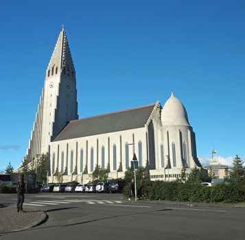 Iceland, Reykjavik, August 3, 2016: Reykjavik Hallgrimskirkja view from back famous iceland modern church from concrete inspired by vulcanic balast pillars with blue sky