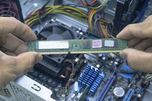 Men hands of Computer technician Cleaning the RAM of the computer.